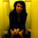 A girl is filmed sitting on a toilet. Maybe she is pooping, maybe not?